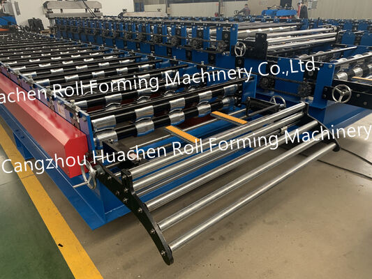 A metal roof panel manufacturing machine for producing tile-shaped corrugated roof panels by rolling process